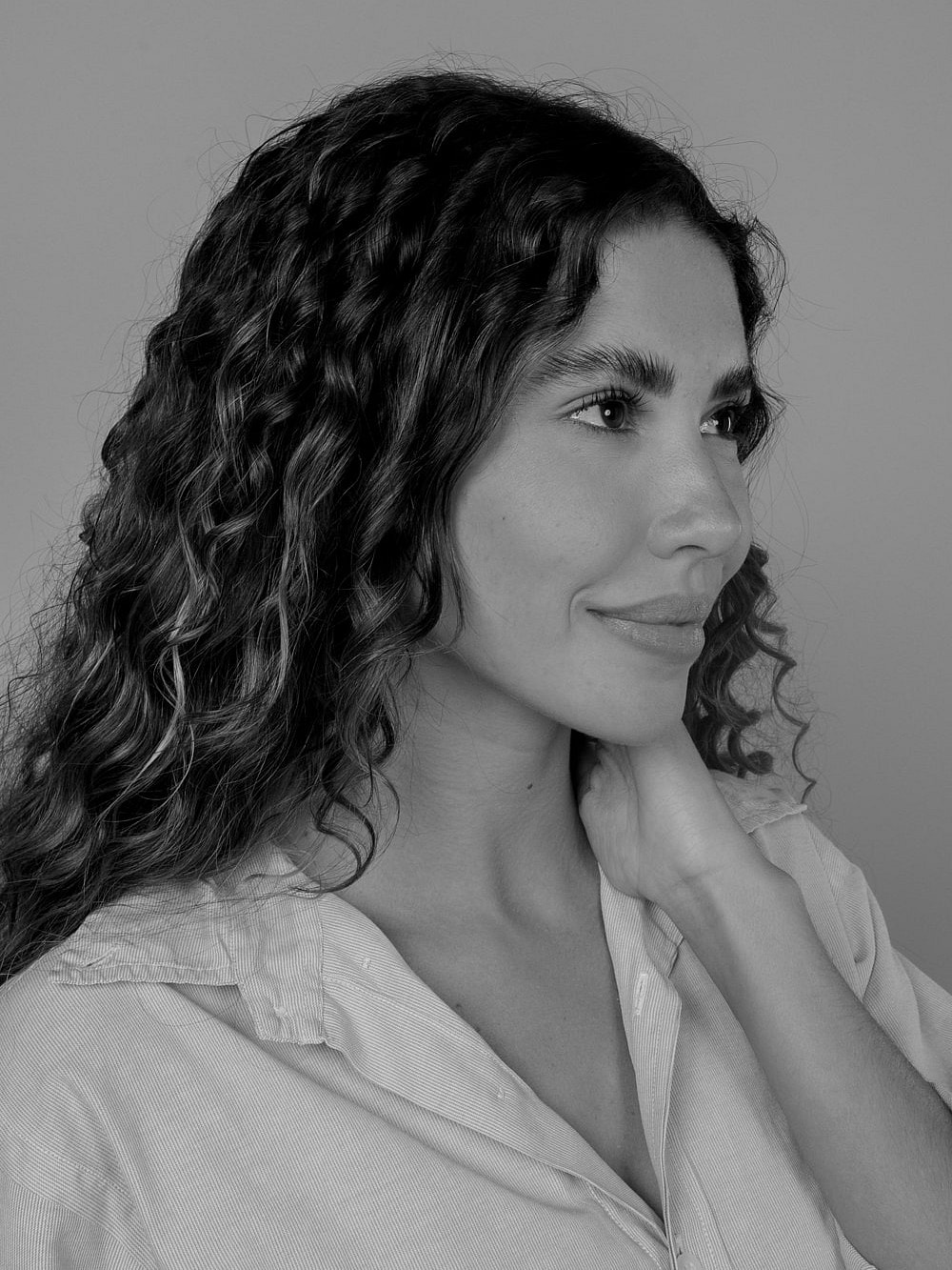 Black and white portrait of a woman smiling.