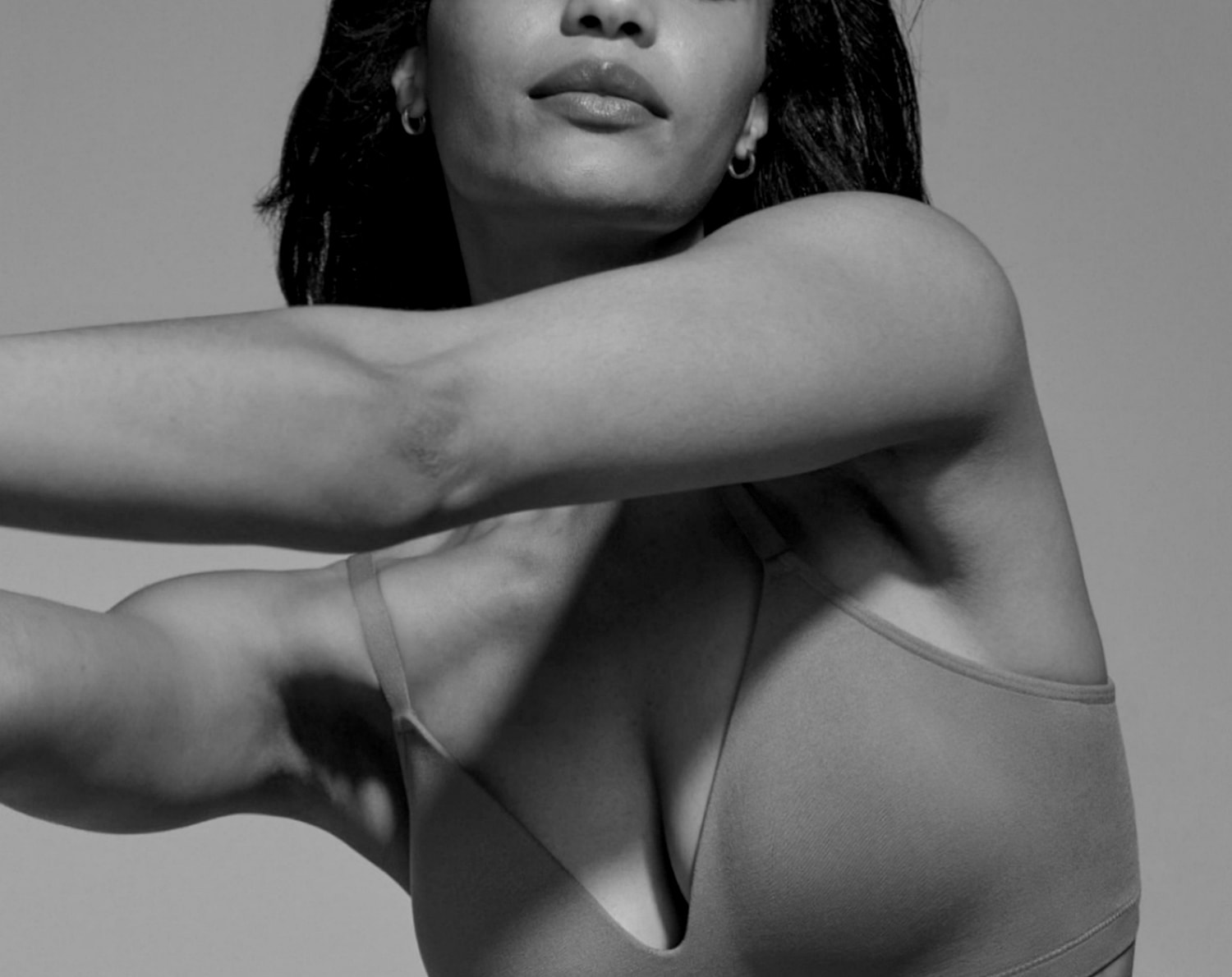 Model wearing sports bra, captured in black and white.