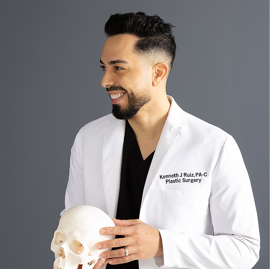 Medical professional holding a skull model.