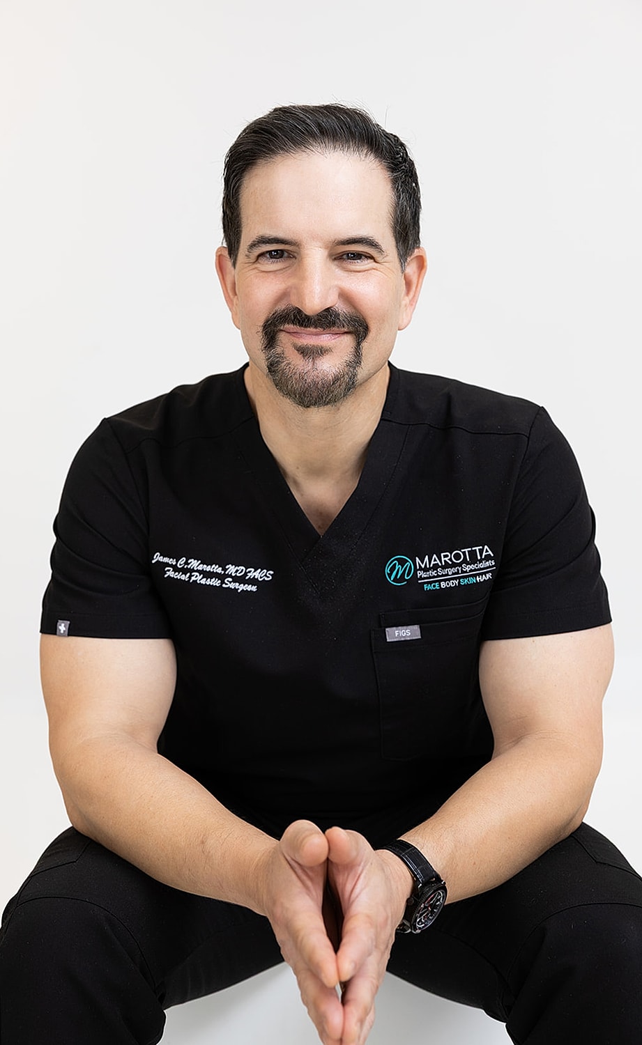 Surgeon posing confidently in operating room.