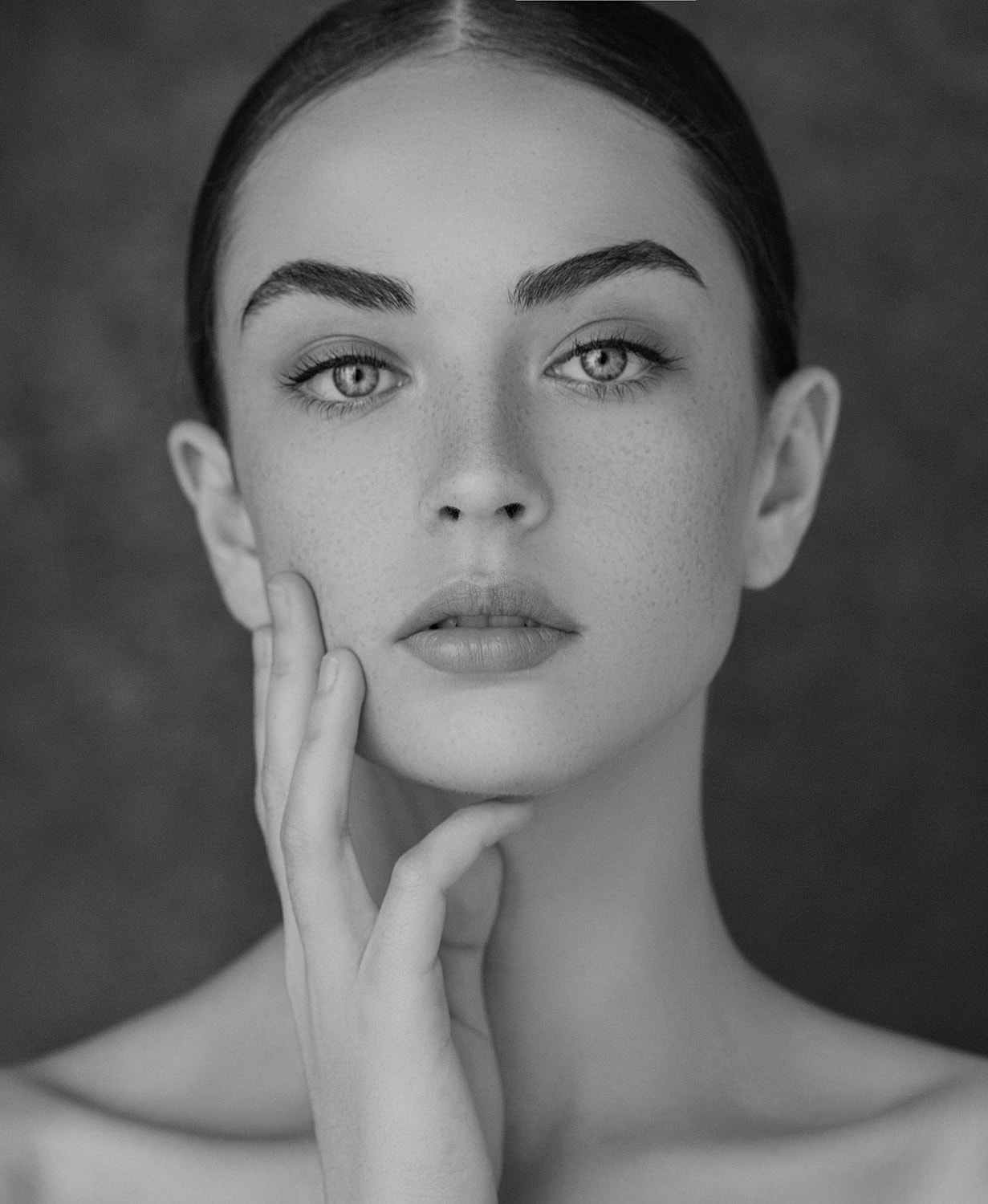 Black and white portrait of a thoughtful woman.
